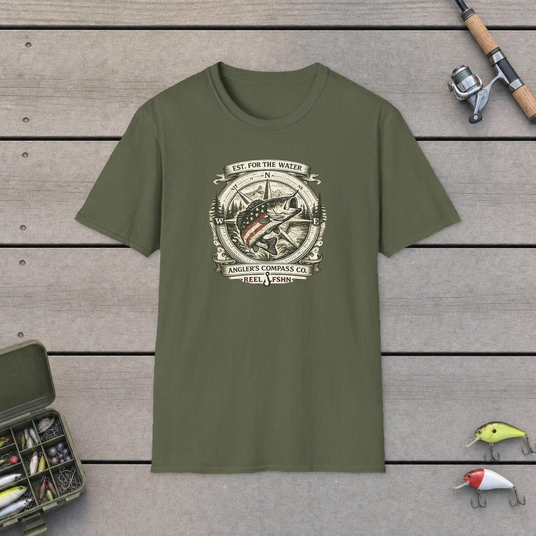 Angler's Compass Company fishing t-shirt on a wooden dock with tackle box and rod