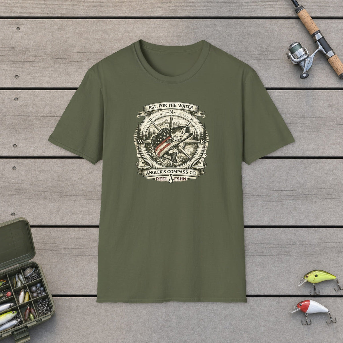 Angler's Compass Company fishing t-shirt on a wooden dock with tackle box and rod