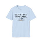 Light blue Comfort Colors unisex t-shirt with "Catch First. Brag Later." text and a fishing hook graphic.
