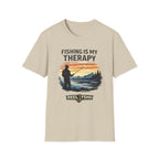 Beige Comfort Colors t-shirt with "Fishing Is My Therapy" text and a graphic of a fisherman at sunset.
