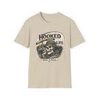 Comfort Colors "Hooked For Life" t-shirt in sand, featuring a fishing skeleton design with a rod and reel.