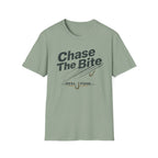 Sage green Comfort Colors t-shirt with "Chase The Bite" text and fishing hook graphic.
