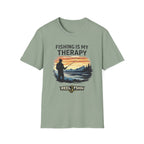 Sage green Comfort Colors unisex t-shirt with "Fishing Is My Therapy" graphic featuring a fisherman at sunset.