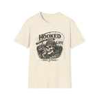 Comfort Colors cream t-shirt with a "Hooked For Life" fishing skull graphic wearing a bucket hat.