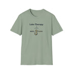Sage green Comfort Colors unisex t-shirt with "Lake Therapy REEL FSHN" text and a fishing hook graphic.