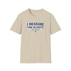 Beige Comfort Colors t-shirt with "I MEASURE TIME IN CASTS" and a fishing hook graphic.