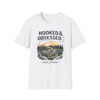 White Comfort Colors unisex tee with "HOOKED & OBSESSED" text and a fishing reel graphic.