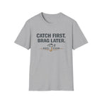 Gray Comfort Colors unisex t-shirt with "Catch First. Brag Later." text and a fishing hook graphic.