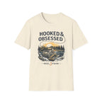 Cream Comfort Colors t-shirt with "Hooked & Obsessed" text and a fishing reel graphic.