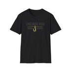 Black Comfort Colors unisex t-shirt with "LIVE REEL FISH" text and a gold fishing hook graphic.