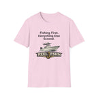 Pink Comfort Colors cotton t-shirt with "Fishing First. Everything Else Second." text, a boat graphic, and "REEL FSHN" logo.