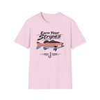 Light pink Comfort Colors unisex t-shirt with "Earn Your Stripes" text and a striped bass graphic.