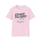 Pink Comfort Colors unisex t-shirt with "Chase The Bite" and "REEL FSHN" fishing hook graphic.