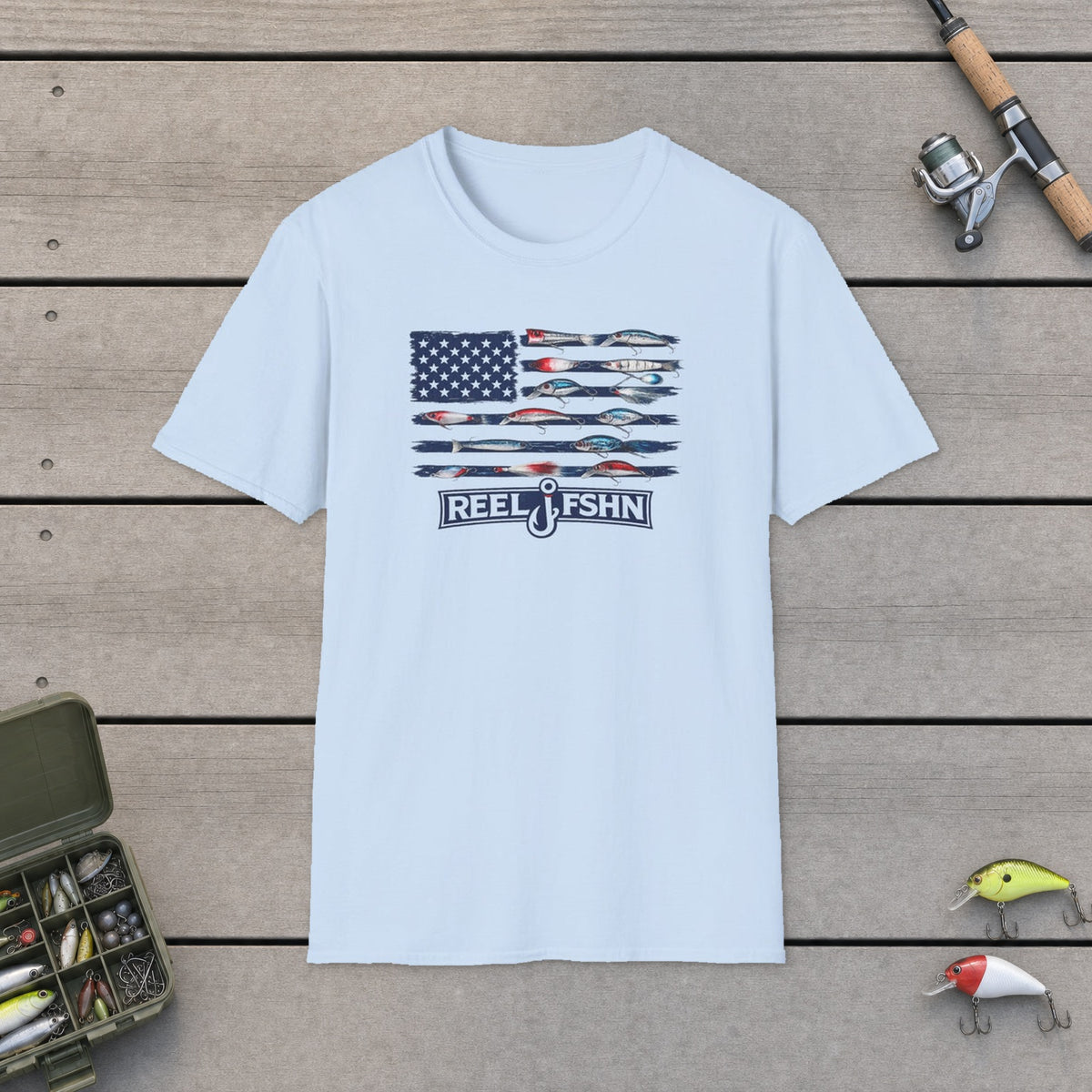 American Flag Lures T-Shirt on a wooden dock with fishing rod, reel, tackle box and lures