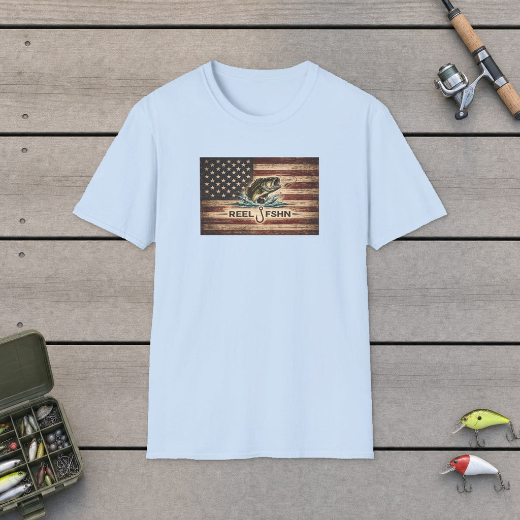 American Flag With Bass T-Shirt flat-laid on wooden dock boards beside a fishing rod and tackle box