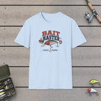 Bait Master T-Shirt on a wooden dock with fishing rod, reel, tackle box and lures