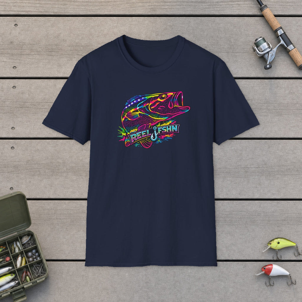 Funky Bass with REEL FSHN Logo T-Shirt flat-laid on wooden dock boards beside a fishing rod and tackle box