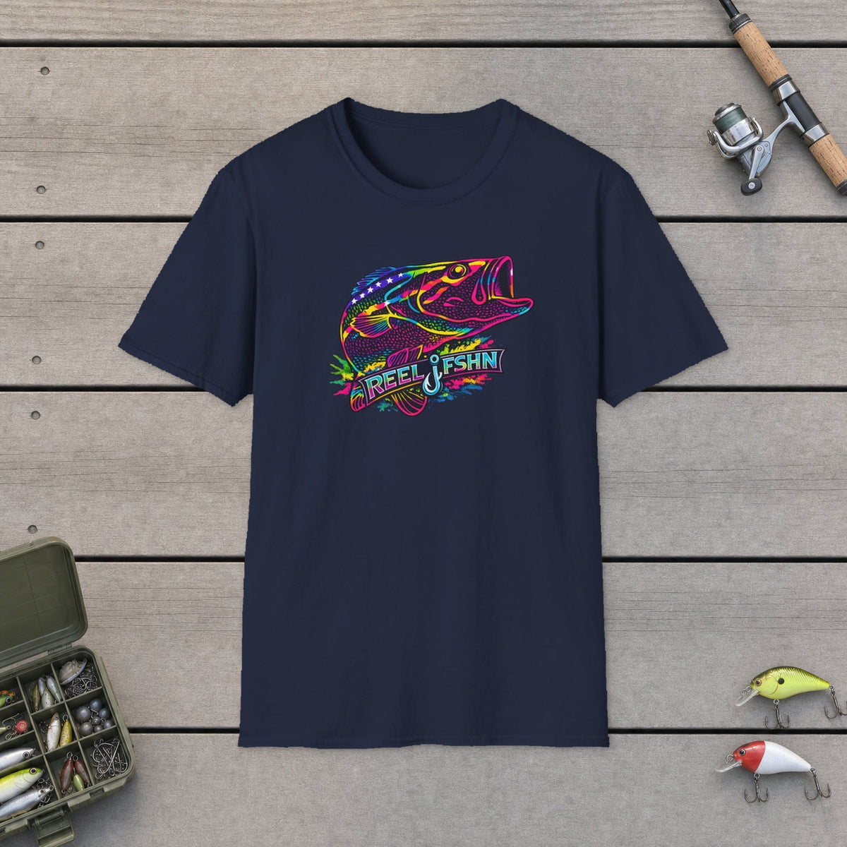 Funky Bass with REEL FSHN Logo T-Shirt on a wooden dock with fishing rod, reel, tackle box and lures