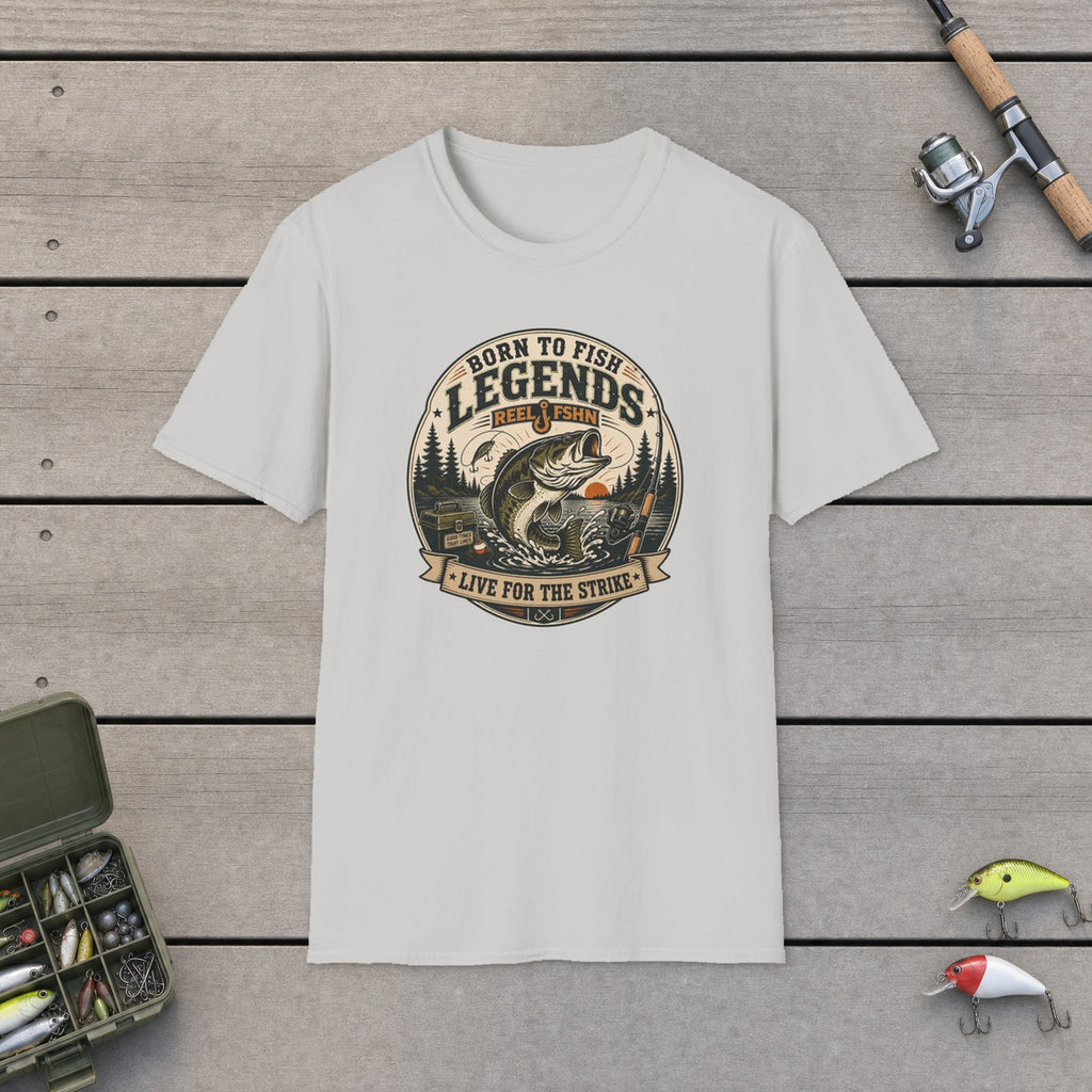 Born To Fish Legends T-Shirt flat-laid on wooden dock boards beside a fishing rod and tackle box
