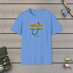 Built For Big Bites T-Shirt on a wooden dock with fishing rod, reel, tackle box and lures