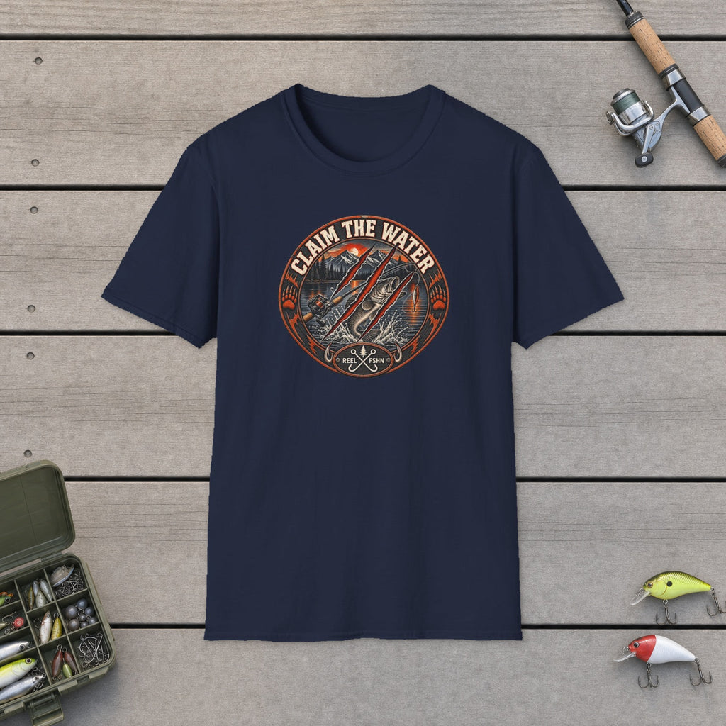 Claim The Water T-Shirt flat-laid on wooden dock boards beside a fishing rod and tackle box