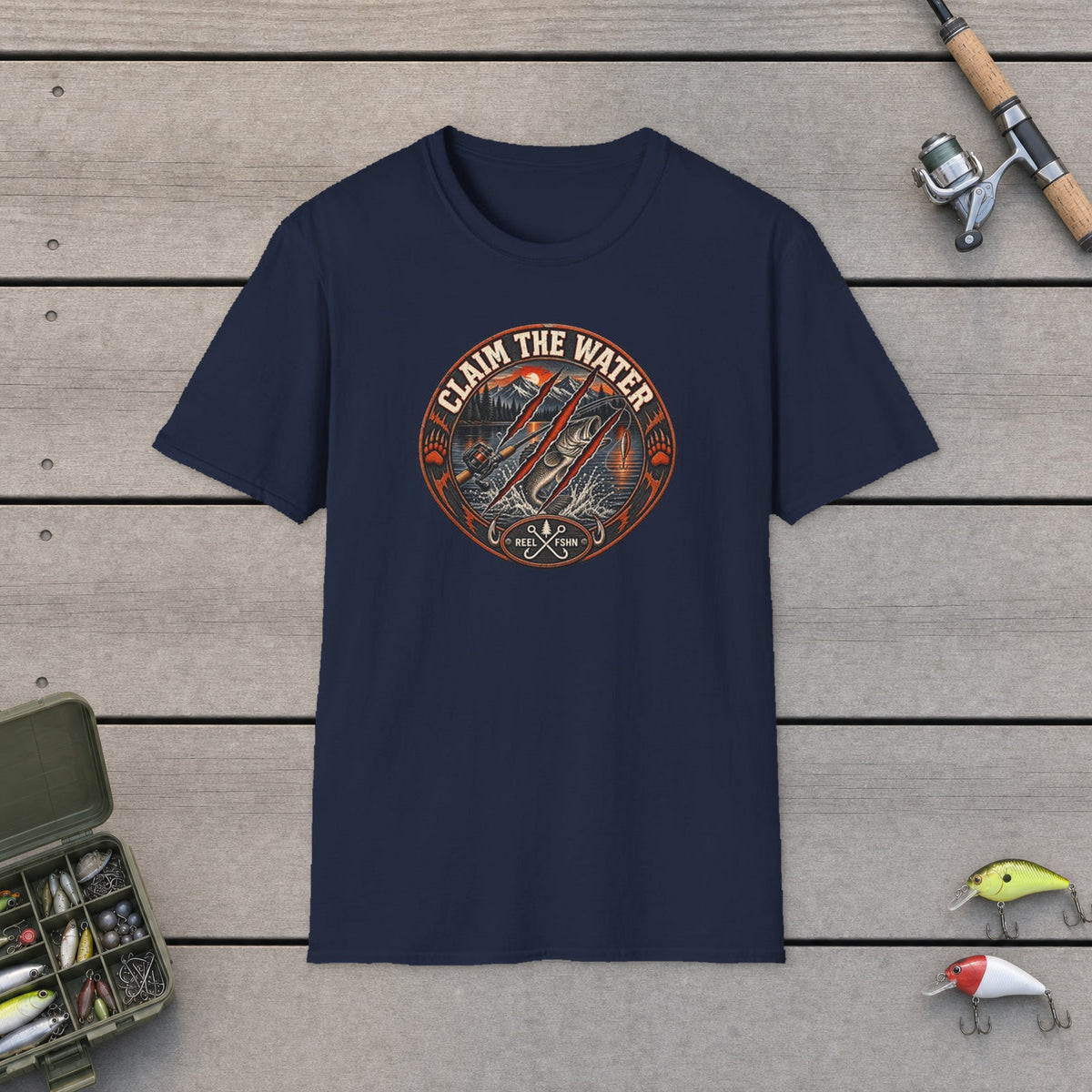 Claim The Water T-Shirt on a wooden dock with fishing rod, reel, tackle box and lures