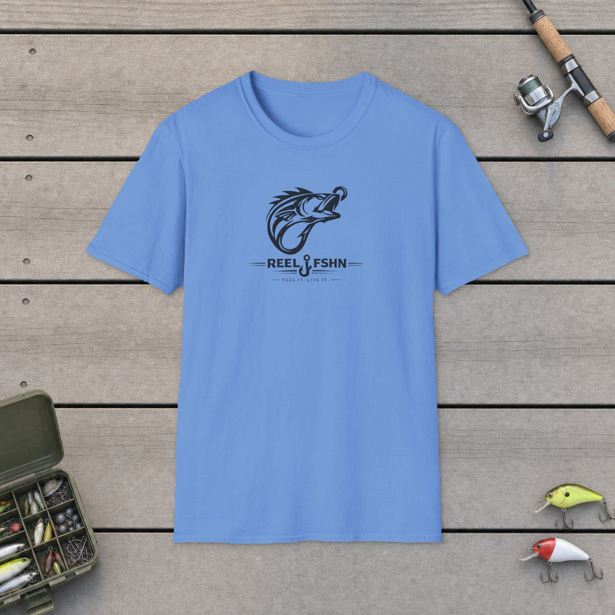 Fish Hook Monogram T-Shirt on a wooden dock with fishing rod, reel, tackle box and lures