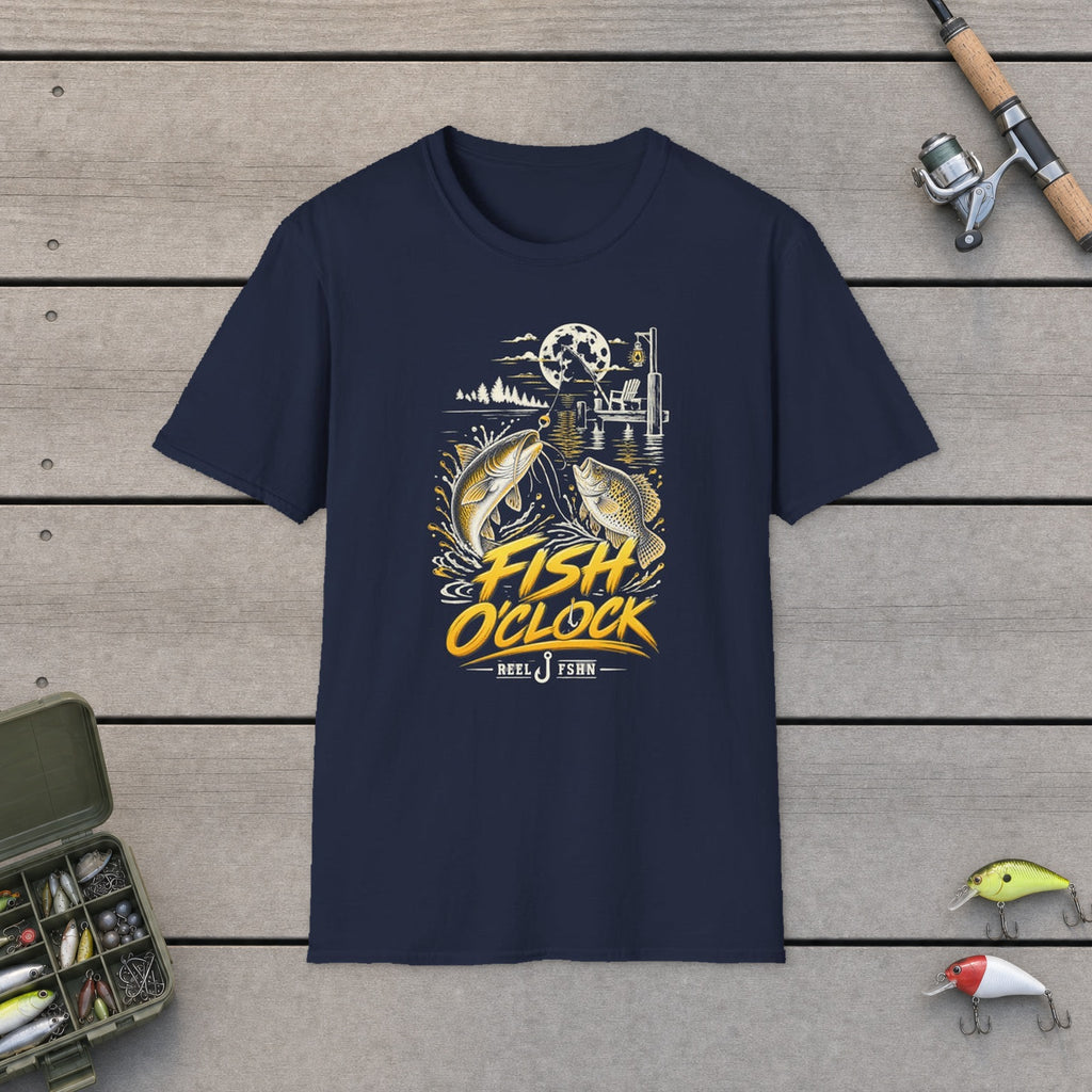 Fish O'Clock T-Shirt flat-laid on wooden dock boards beside a fishing rod and tackle box