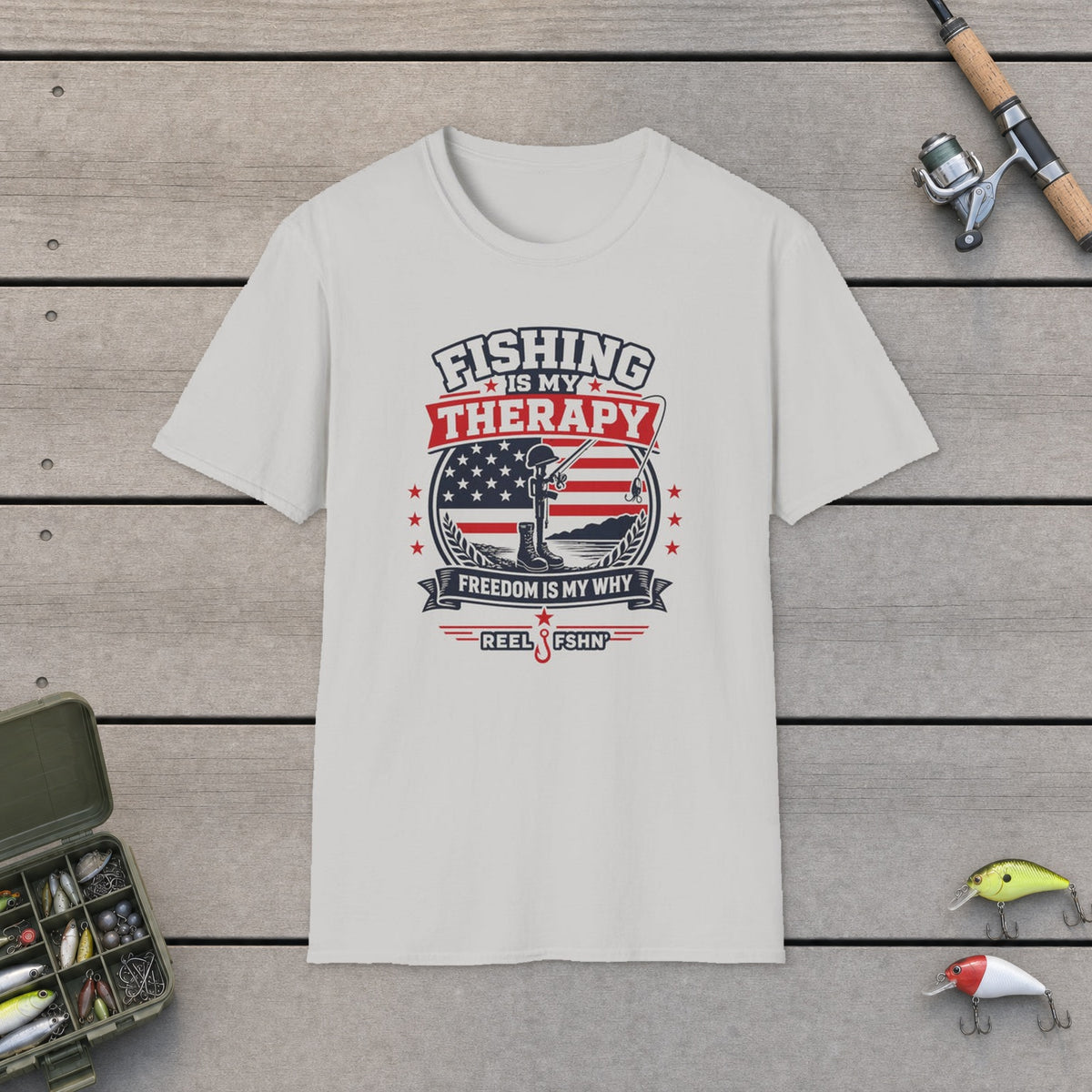 Fishing Is My Therapy Freedom Is My Why T-Shirt on a wooden dock with fishing rod, reel, tackle box and lures