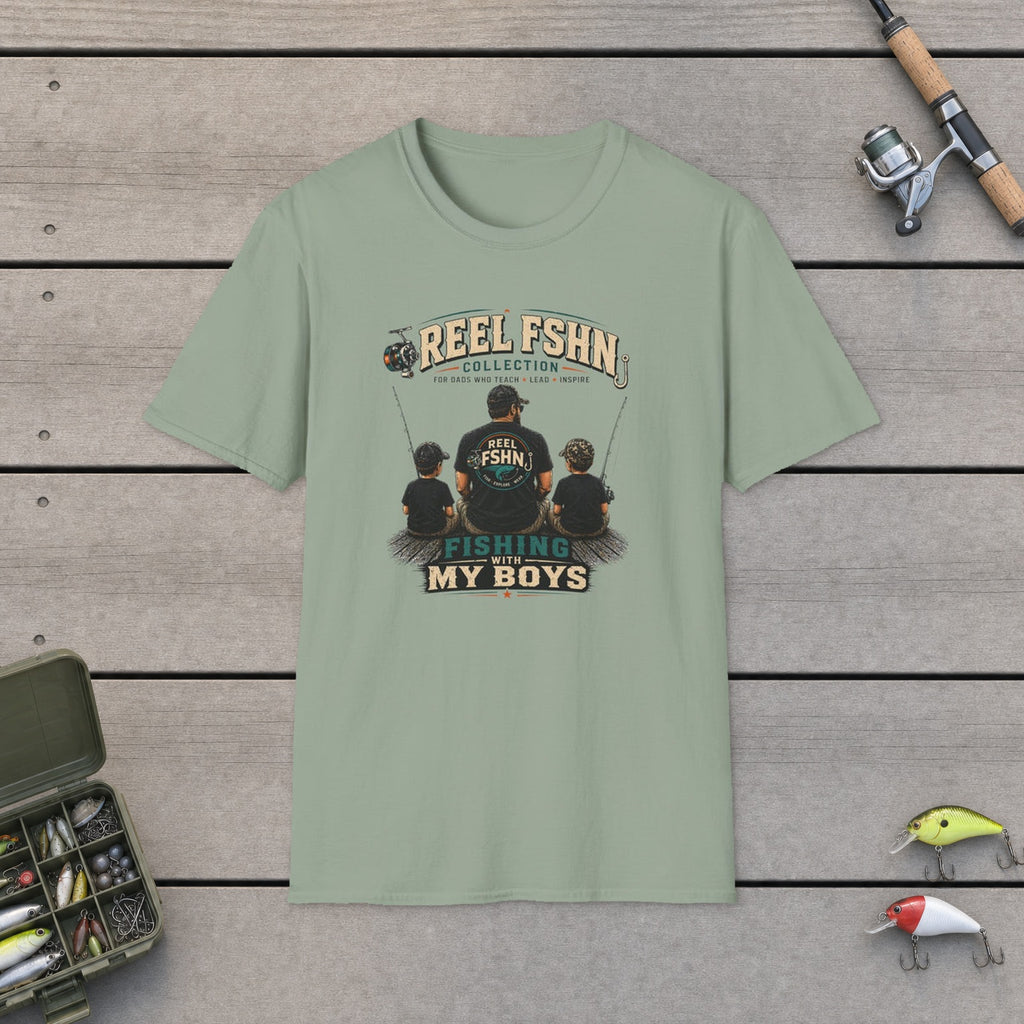 Fishing With My Boys T-Shirt flat-laid on wooden dock boards beside a fishing rod and tackle box