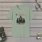 Fishing With My Boys T-Shirt on a wooden dock with fishing rod, reel, tackle box and lures