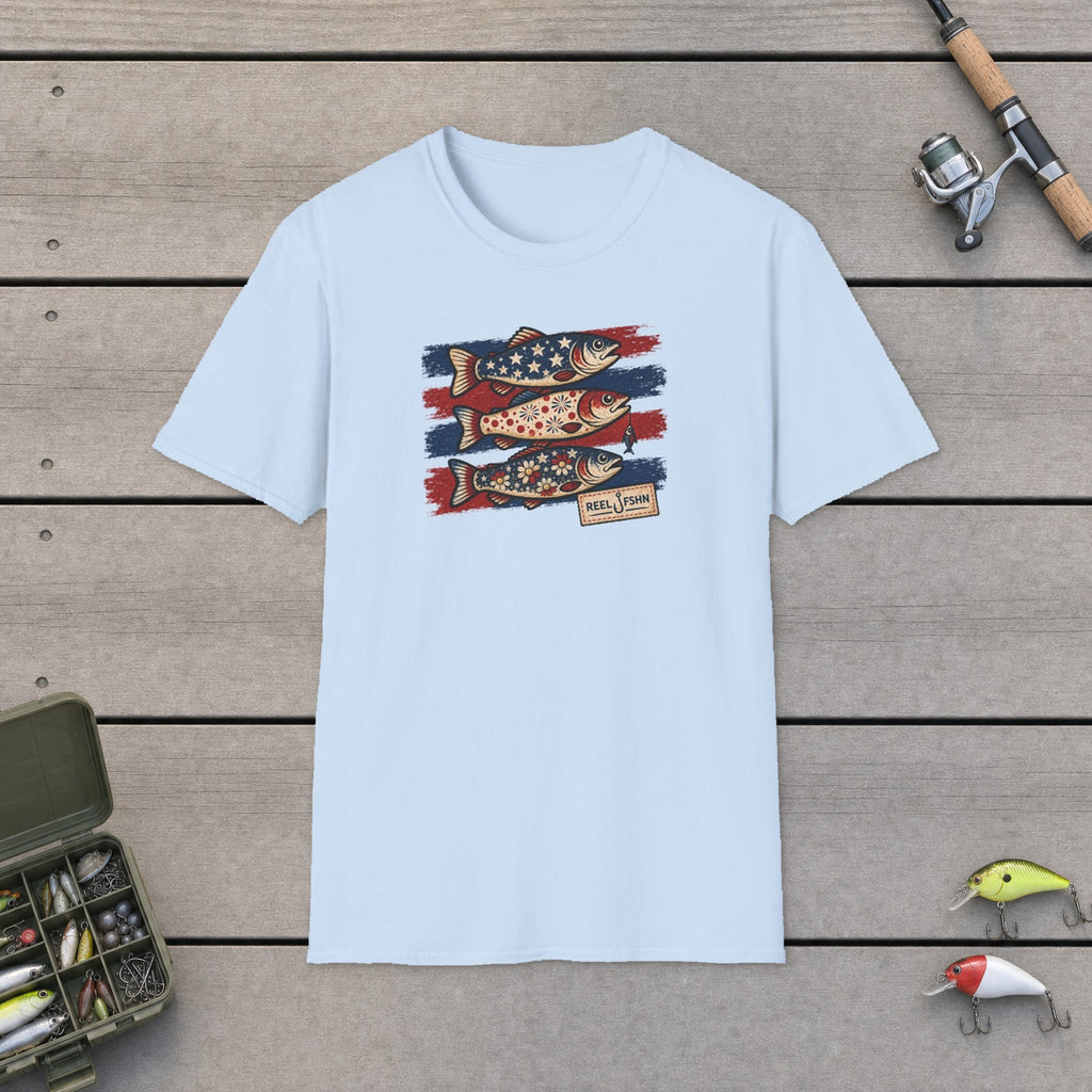 Flowery Fish & Stars T-Shirt flat-laid on wooden dock boards beside a fishing rod and tackle box