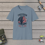 Freedom Isn't Free T-Shirt on a wooden dock with fishing rod, reel, tackle box and lures