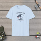 Freedom To Fish T-Shirt on a wooden dock with fishing rod, reel, tackle box and lures