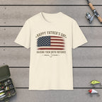 Happy Father's Day Raising Them With Patience T-Shirt on a wooden dock with fishing rod, reel, tackle box and lures