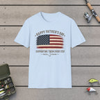 Happy Father's Day Supporting Them Every Step T-Shirt on a wooden dock with fishing rod, reel, tackle box and lures