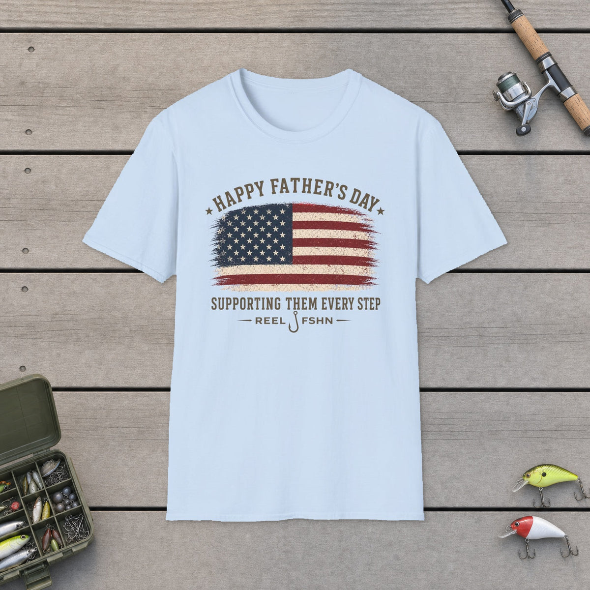 Happy Father's Day Supporting Them Every Step T-Shirt on a wooden dock with fishing rod, reel, tackle box and lures