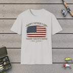 Happy Father's Day Teaching Them With Purpose T-Shirt on a wooden dock with fishing rod, reel, tackle box and lures