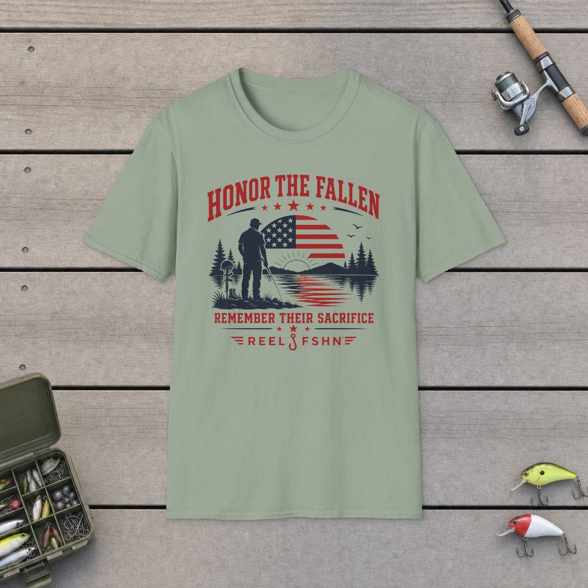 Honor The Fallen Remember Their Sacrifice T-Shirt on a wooden dock with fishing rod, reel, tackle box and lures