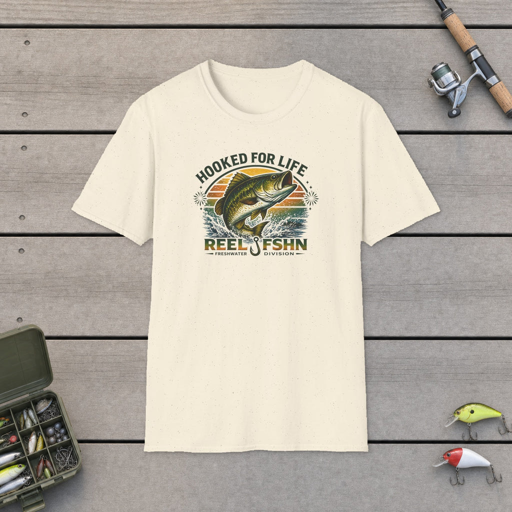 Hooked For Life T-Shirt flat-laid on wooden dock boards beside a fishing rod and tackle box