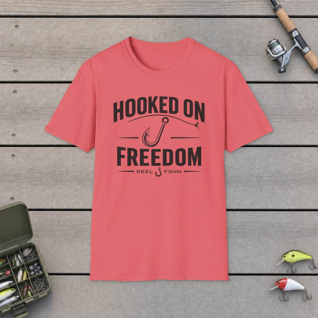 Hooked On Freedom  T-Shirt flat-laid on wooden dock boards beside a fishing rod and tackle box