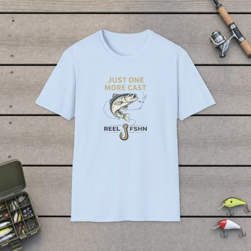 Just One More Cast  T-Shirt flat-laid on wooden dock boards beside a fishing rod and tackle box