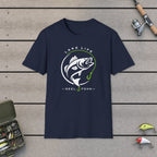 Lake Life T-Shirt on a wooden dock with fishing rod, reel, tackle box and lures