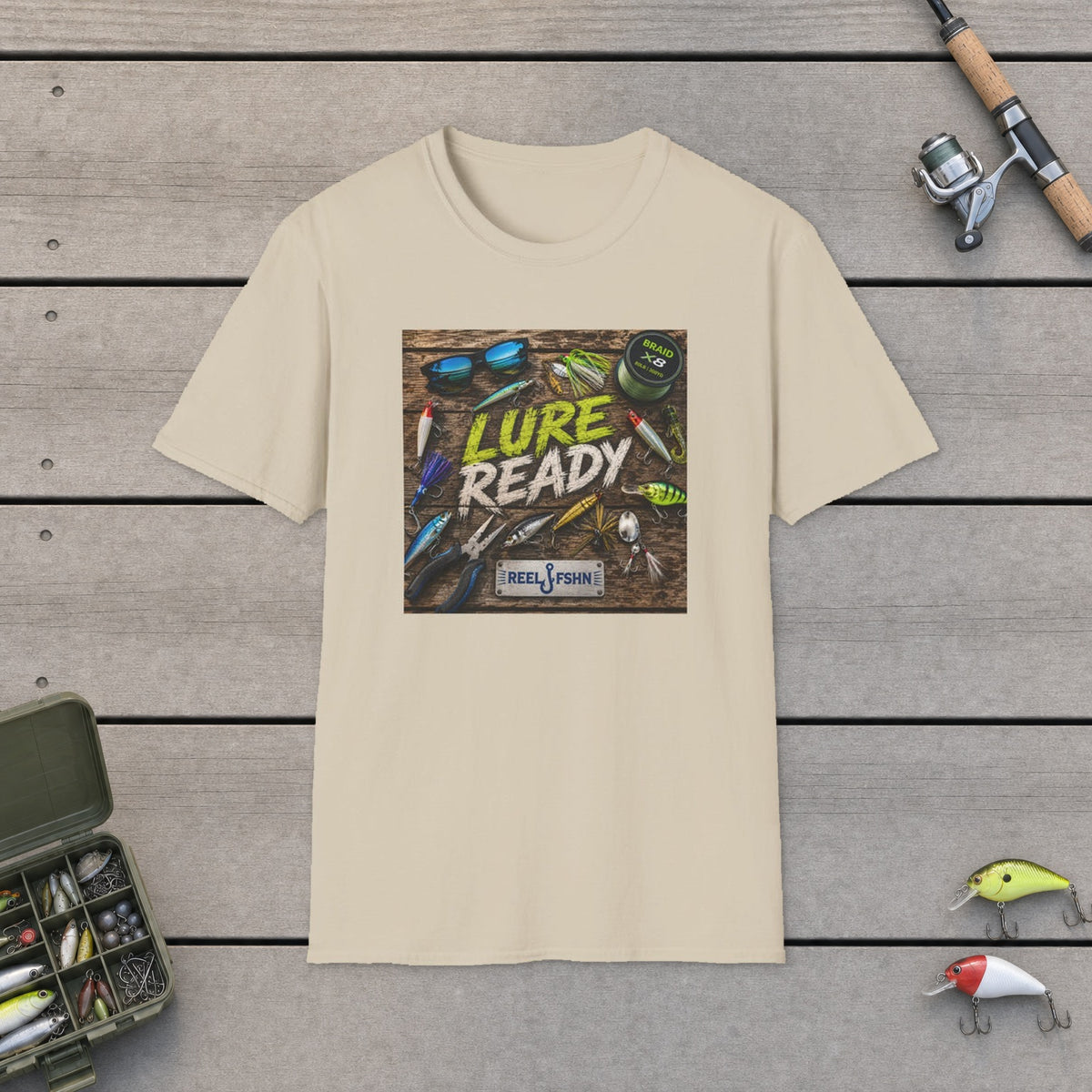 Lure Ready Gear  T-Shirt on a wooden dock with fishing rod, reel, tackle box and lures