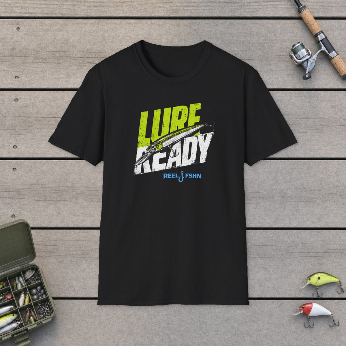 Lure Ready Slanted Logo  T-Shirt on a wooden dock with fishing rod, reel, tackle box and lures