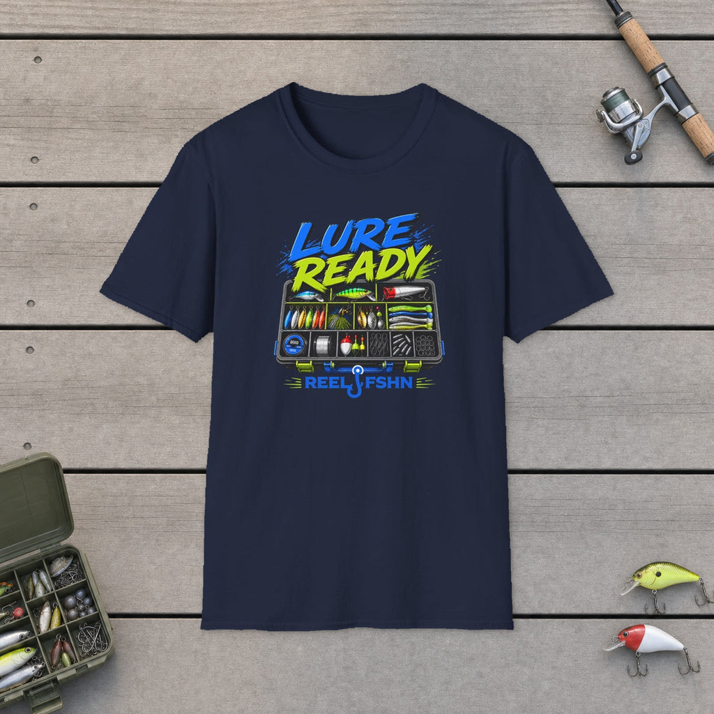 Lure Ready Tacklebox  T-Shirt flat-laid on wooden dock boards beside a fishing rod and tackle box