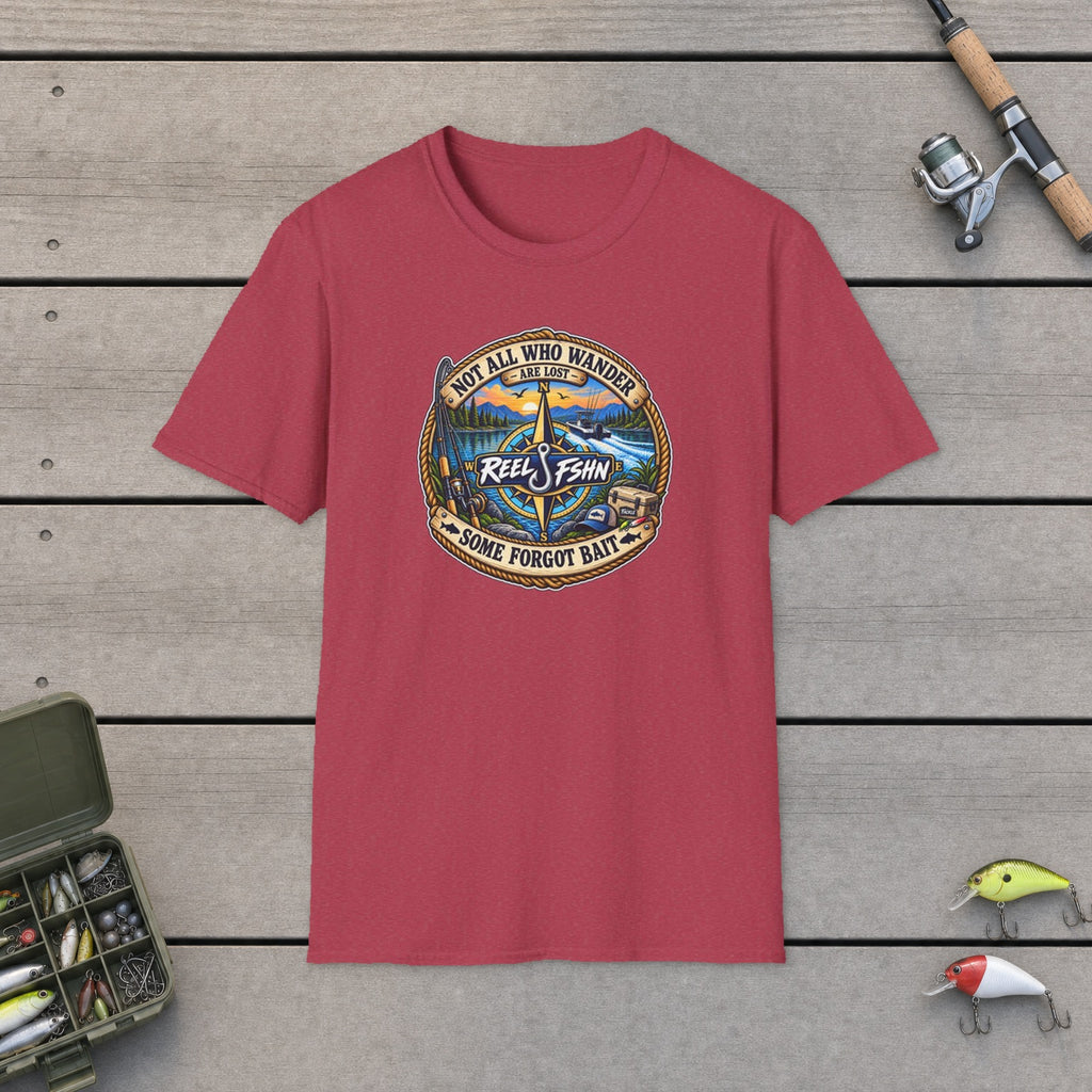 Not All Who Wander Are Lost T-Shirt flat-laid on wooden dock boards beside a fishing rod and tackle box