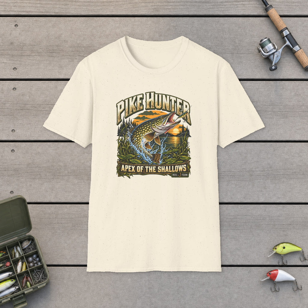 Pike Hunter T-Shirt flat-laid on wooden dock boards beside a fishing rod and tackle box