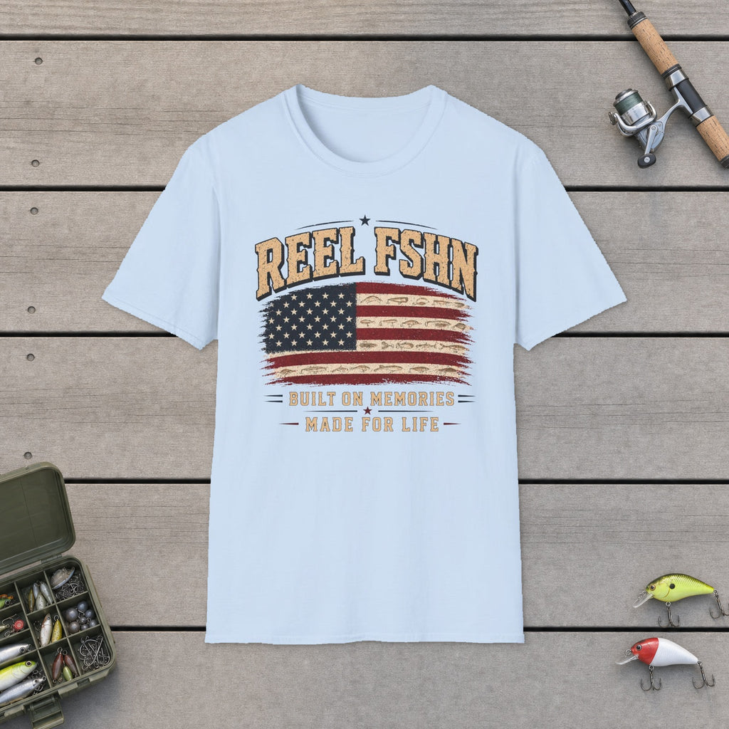 REEL FSHN Built On Memories Made For Life T-Shirt flat-laid on wooden dock boards beside a fishing rod and tackle box