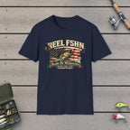 REEL FSHN Built On Memories T-Shirt on a wooden dock with fishing rod, reel, tackle box and lures